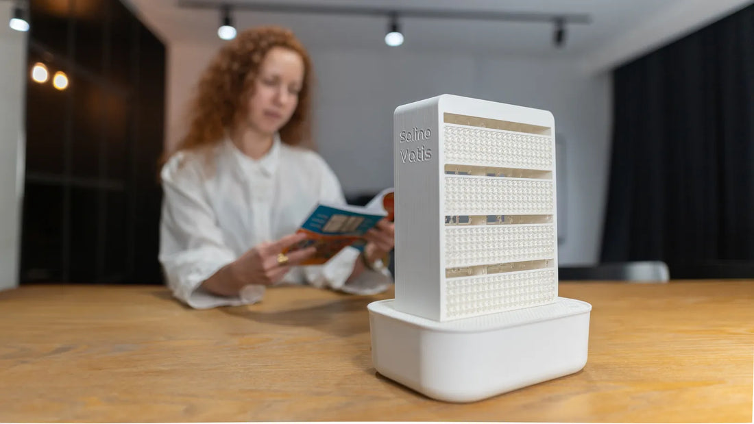 White SalinoVatis Vita on a wooden table, with a woman reading a brochure in the background